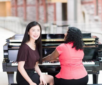 Girl having piano lessons