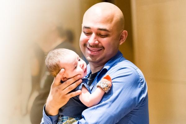 man carrying baby